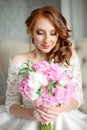 Portrait of beautiful red-haired girl sitting, smiling on big arm-chair. Royalty Free Stock Photo