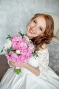 Portrait of beautiful red-haired girl sitting, smiling on big arm-chair. Royalty Free Stock Photo