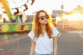 Portrait of a beautiful red-haired girl in sunglasses at sunset Royalty Free Stock Photo