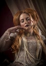 Portrait of beautiful red haired woman dressed in period costume as Elizabeth I Royalty Free Stock Photo
