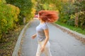 Portrait Beautiful red-haired woman in glasses and a gray T-shirt walks in the park and flirts. A happy girl turns Royalty Free Stock Photo