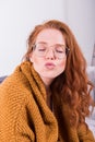 Portrait beautiful red-haired woman in orange cardigan with kis Royalty Free Stock Photo