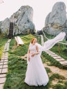 Portrait of beautiful redhair bride posing near rocks. Honeymoon at Carpathians in Tustan fortress Royalty Free Stock Photo