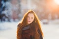 Portrait beautiful redhair girl in frosty winter weather.