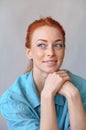 Cheerful redhead woman smiling, thinking of something nice Royalty Free Stock Photo