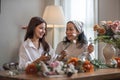 Portrait of a beautiful retired Asian woman focuses on arranging a vase with fresh flowers in a workshop. Lifestyle Royalty Free Stock Photo