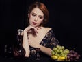 Portrait of beautiful rich women with grapes.