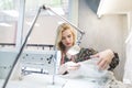 Beautiful seamstress in the workplace near a sewing machine Royalty Free Stock Photo