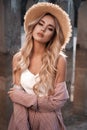 Portrait of a beautiful, seductive and elegant young woman with long loose blonde hair in a straw hat. Countryside landscape Royalty Free Stock Photo