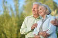 Portrait of beautiful senior couple hugging on a lilac background in the park Royalty Free Stock Photo