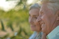 Portrait of beautiful senior couple hugging on a lilac background in the park Royalty Free Stock Photo