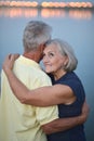 Portrait of beautiful senior couple hugging on a lilac background in the park Royalty Free Stock Photo