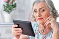 Portrait of beautiful senior woman using modern tablet Royalty Free Stock Photo