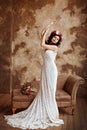 Portrait of beautiful sensual brunette girl in a white lace dress, with a wreath of flowers on her head, in full growth on a brow Royalty Free Stock Photo