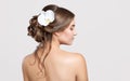 Portrait of a beautiful sensual light brown haired woman with a wedding hairstyle and nude make-up in a beauty salon. In the hair Royalty Free Stock Photo