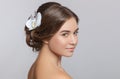 Portrait of a beautiful sensual light brown haired woman with a wedding hairstyle and nude make-up in a beauty salon. In the hair Royalty Free Stock Photo