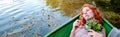 Portrait of beautiful sensual, seductive, young sexy redhead girl with a longing, bride, with a bouquet of flowers lying in a boat Royalty Free Stock Photo