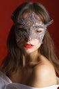 Portrait beautiful sensual woman in black lace mask on red background. Sexy Royalty Free Stock Photo