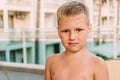Portrait of a beautiful seven-year-old blond boy in the summer