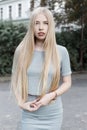 Portrait of a beautiful cute girl with long blond hair in a gray suit with full lips Royalty Free Stock Photo