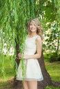 Portrait of beautiful happy smiling girl with big full lips, with white hair in a white dress Royalty Free Stock Photo