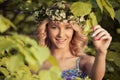 Beautiful smiling girl with a wreath on his head in the spring park Royalty Free Stock Photo