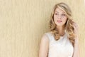 Portrait of a beautiful smiling happy girl with big full lips with blond hair in a white dress on a sunny bright day