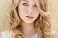 Portrait of a beautiful smiling happy girl with big full lips with blond hair in a white dress on a sunny bright day Royalty Free Stock Photo