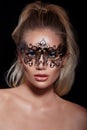 Sexy model woman in venetian masquerade carnival mask on black background. Glamour lady Royalty Free Stock Photo