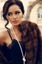 Portrait of beautiful woman with dark hair in luxurious fur coat Royalty Free Stock Photo