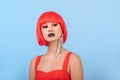 Portrait of beautiful sexy woman in red wig Bob hairstyle. Long earring Royalty Free Stock Photo