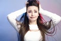 Portrait of a beautiful shocked girl with long hair on studio background, young woman with grimace of self-pity and disappointment Royalty Free Stock Photo