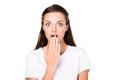 portrait of beautiful shocked woman covering mouth with hand and looking at camera Royalty Free Stock Photo