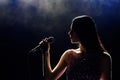 Portrait of beautiful singing woman on dark background Royalty Free Stock Photo