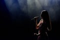 Portrait of beautiful singing woman on dark background. Royalty Free Stock Photo