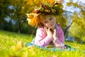 portrait of the beautiful six-year-old girl in a wreath from autumn leaves Royalty Free Stock Photo