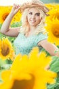 Portrait of a beautiful smiling blonde girl in a straw hat outdoors Royalty Free Stock Photo