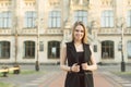 A portrait of a beautiful smiling caucasian college student girl at campus yard. Young pretty female student with broad smile Royalty Free Stock Photo