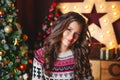 Portrait of beautiful smiling curly women near christmas tree. Celebration Royalty Free Stock Photo