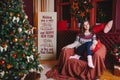 Portrait of beautiful smiling curly women near christmas tree. Celebration Royalty Free Stock Photo