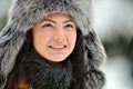 Portrait of beautiful smiling female wearing luxurious fur cap