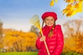 Portrait of beautiful smiling girl with rake