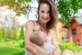 Portrait of beautiful smiling happy young other brest feeding cute little baby boy outdoors. Mom holding and breastfeeding child Royalty Free Stock Photo