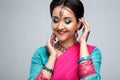 Portrait of beautiful smiling indian girl. Young indian woman model with traditional jewelry set Royalty Free Stock Photo