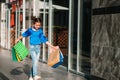 Portrait of beautiful smiling little girl wearing with shopping bag outdoors Royalty Free Stock Photo