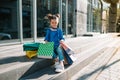 Portrait of beautiful smiling little girl wearing with shopping bag outdoors Royalty Free Stock Photo