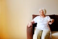 Portrait of a beautiful smiling senior woman with walking cane on light background at home Royalty Free Stock Photo