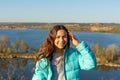 Portrait of a beautiful smiling teen girl on a lake background