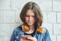 Portrait of beautiful smiling teenage girl of 14, 15 years old with smartphone Royalty Free Stock Photo