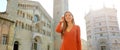 Portrait of beautiful smiling tourist woman in Parma with Cathedral, Bell tower and Baptistery. Panoramic view of traveler girl Royalty Free Stock Photo